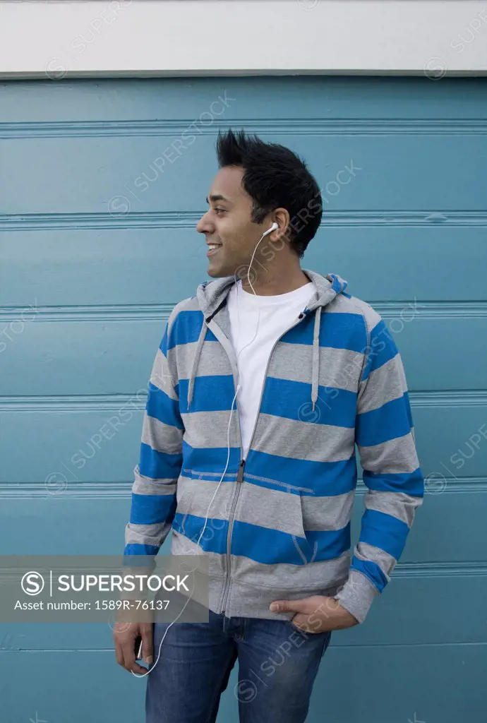 Mixed race man listening to headphones