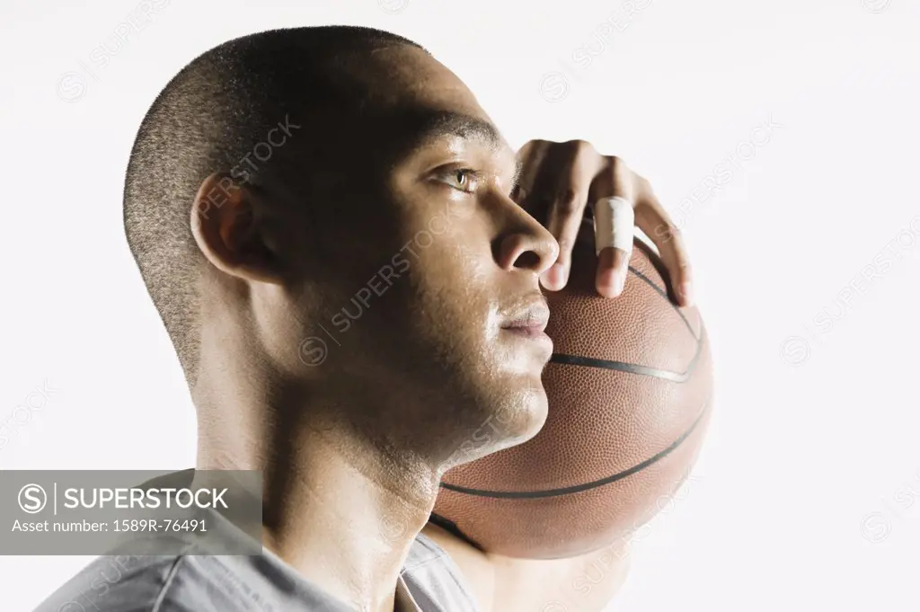 African man holding basketball
