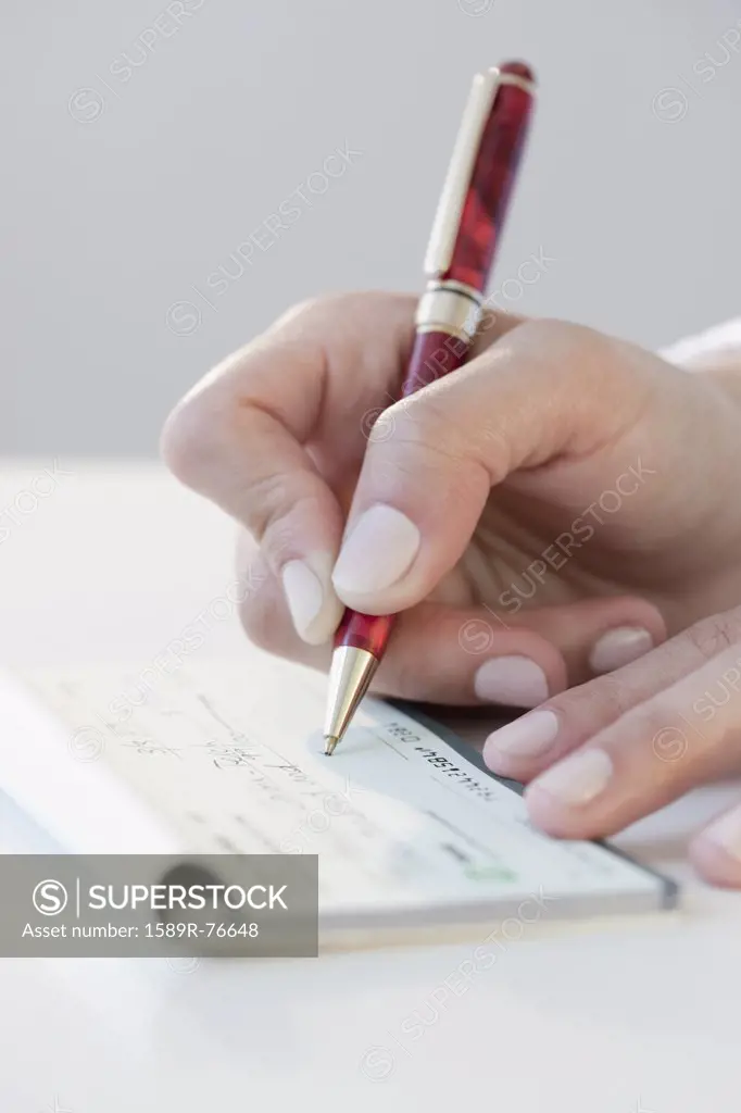 Woman writing personal check