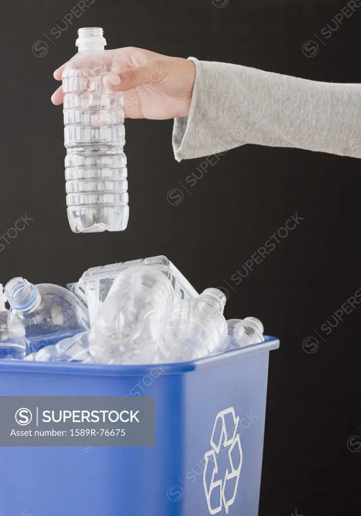 Woman recycling plastic bottle