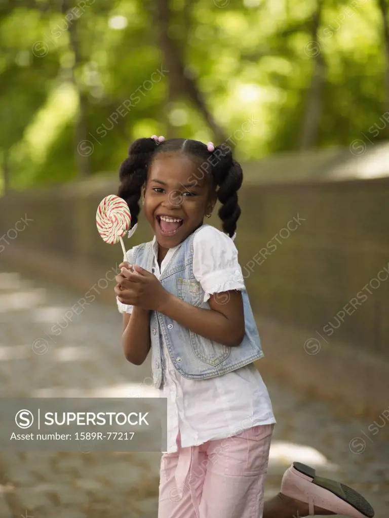 African girl holding lollipop