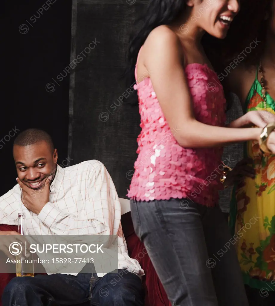African man eyeing women in nightclub