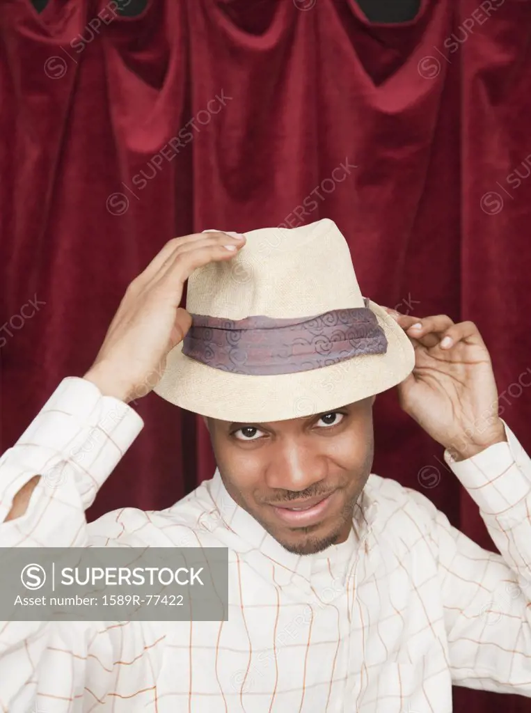 African man in hat acting cool