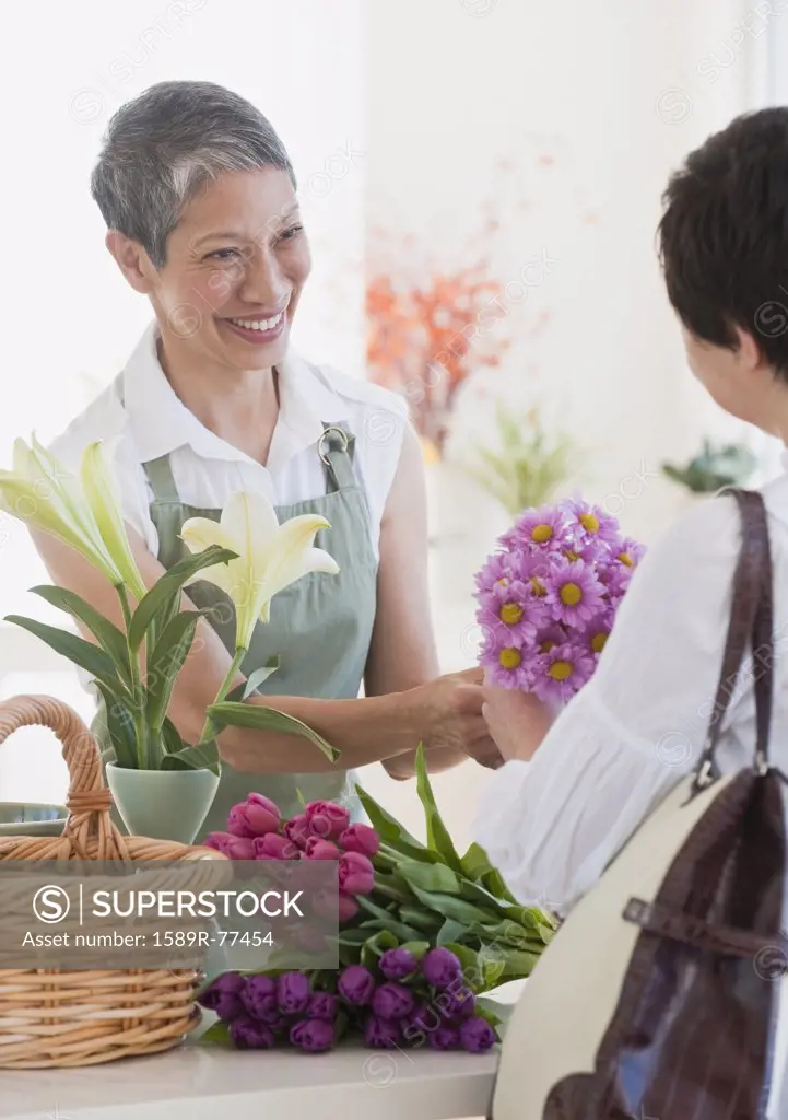 Chinese florist giving flowers to customer