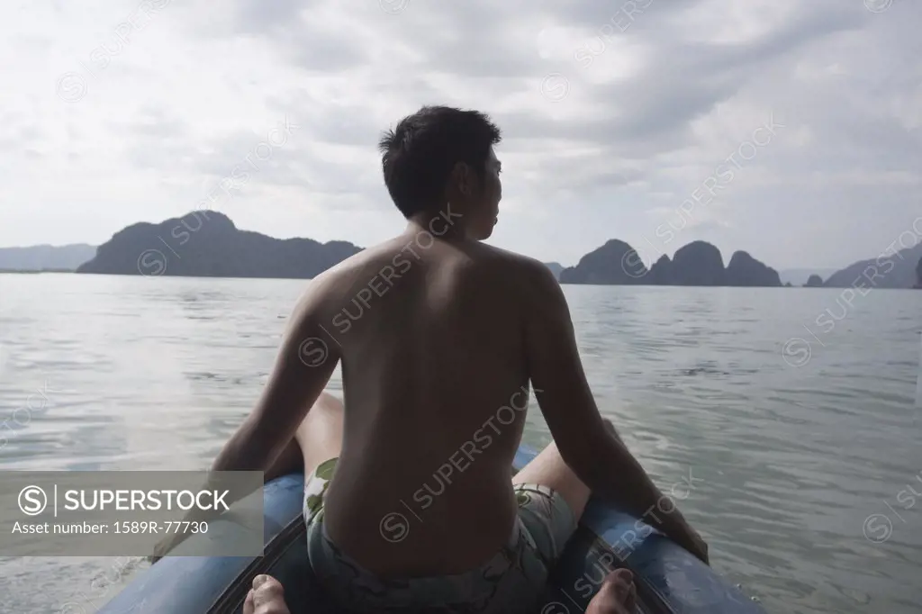 Chinese man on boat in ocean