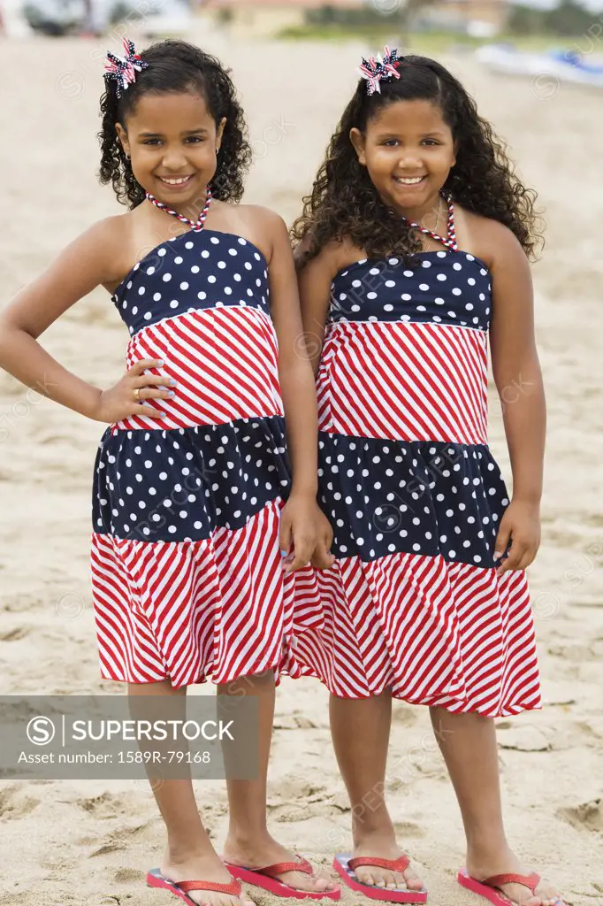 Hispanic girls in sundresses on beach