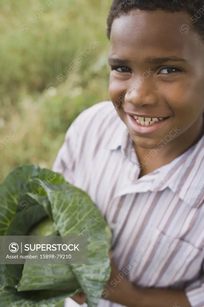 African boy holding cabbage