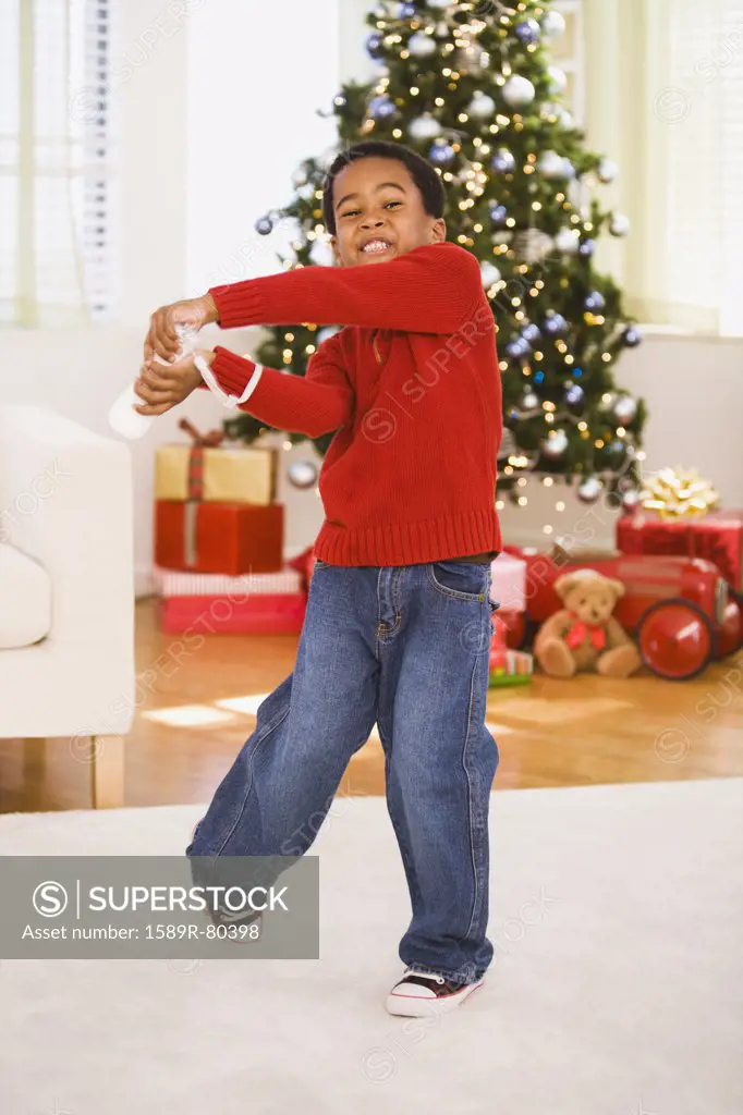 African boy playing video game at Christmas