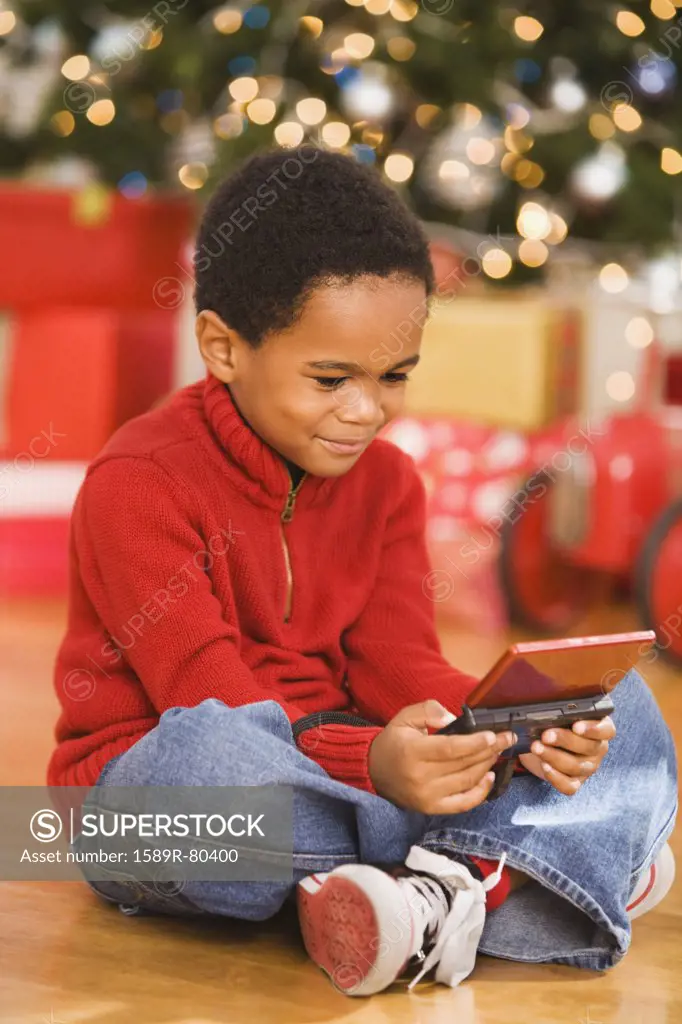 African boy playing video game at Christmas