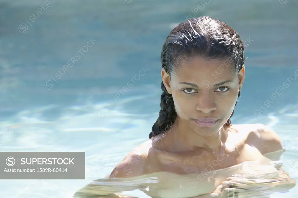 Nude mixed race woman in swimming pool