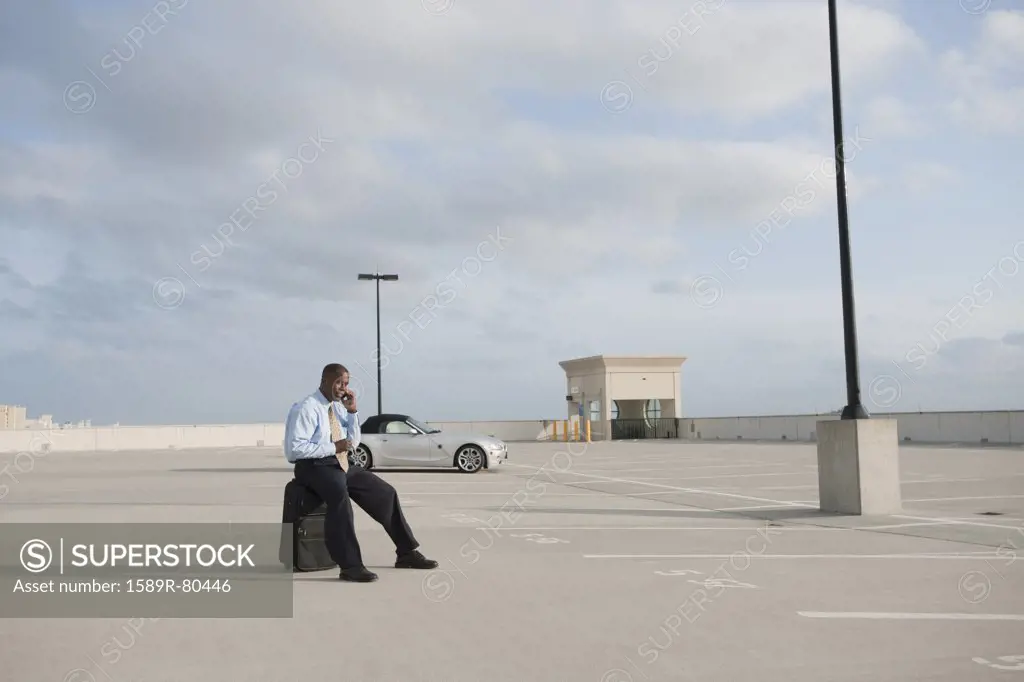 African businessman waiting in parking lot