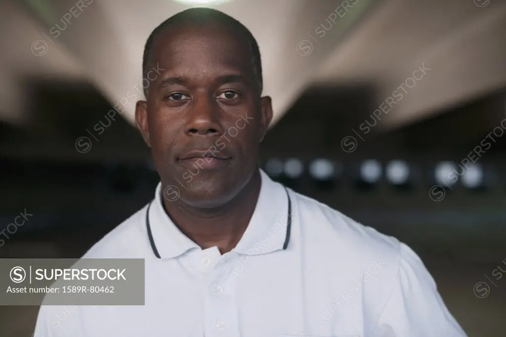 African man standing in parking garage