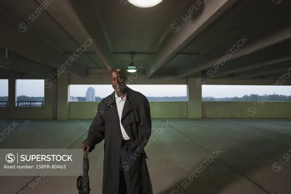 African businessman standing in parking garage
