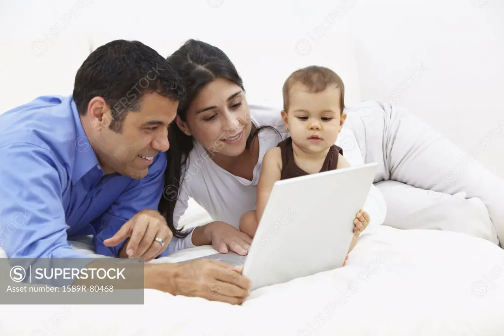 Hispanic family looking at laptop