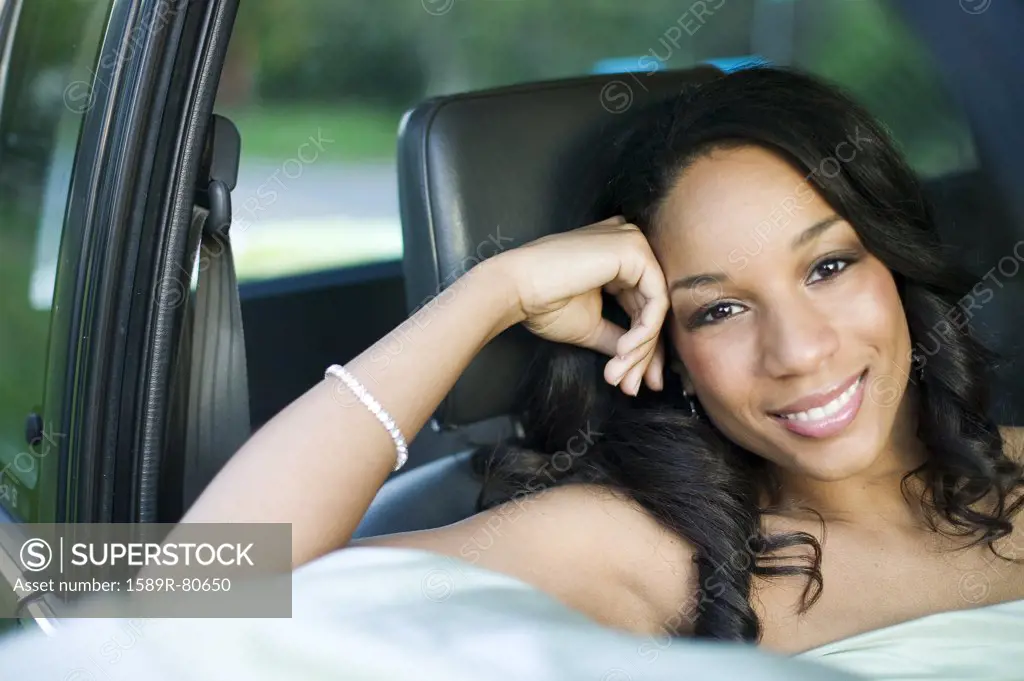 African woman sitting in passenger seat of car