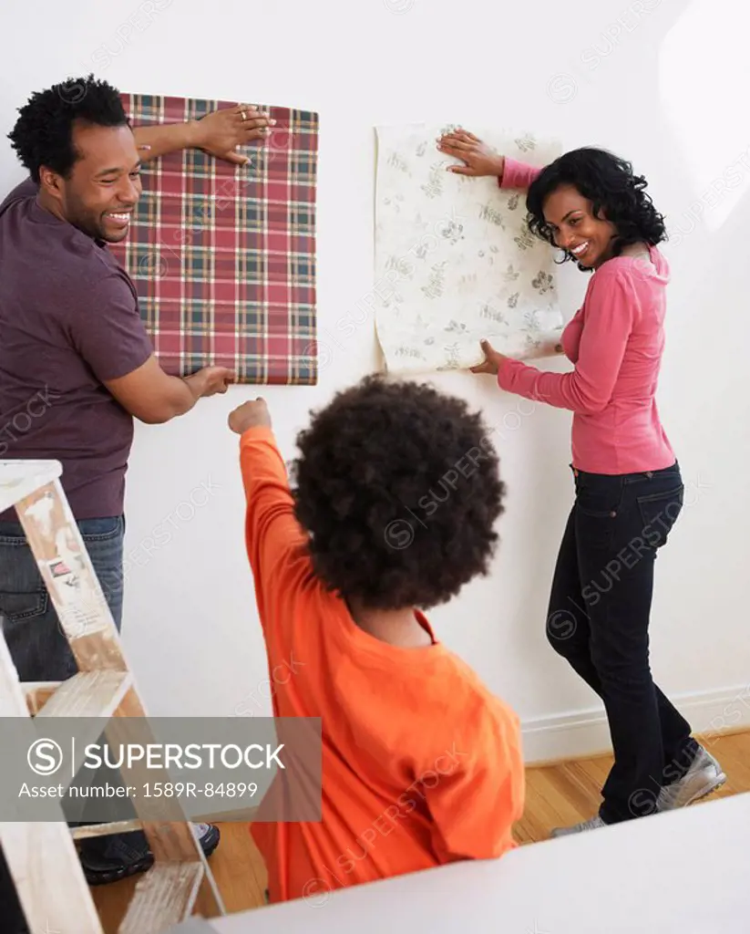 African son helping parents choose wallpaper