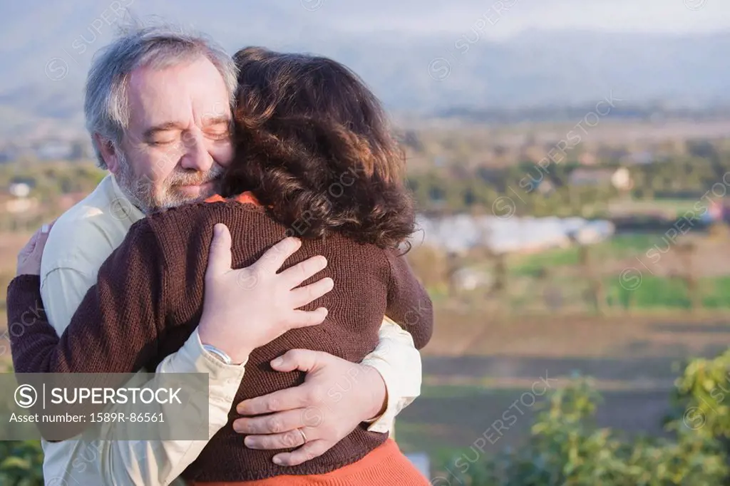 Hispanic couple hugging