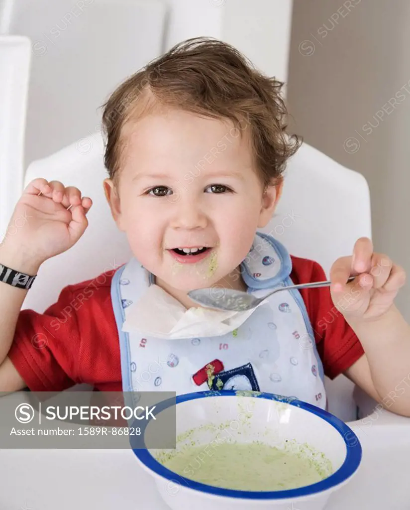 Hispanic boy eating cereal