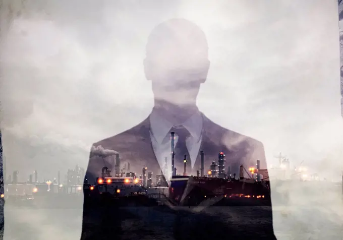 Double exposure of businessman and power plant