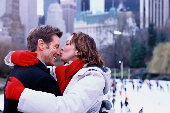 Couple kissing outside Rockefeller Center, New York City, New York, United States