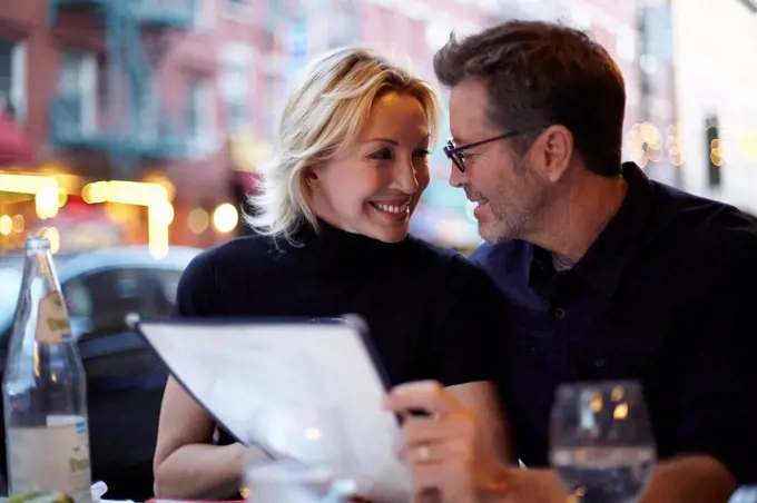 Caucasian couple eating at urban cafe, New York City, New York, United States