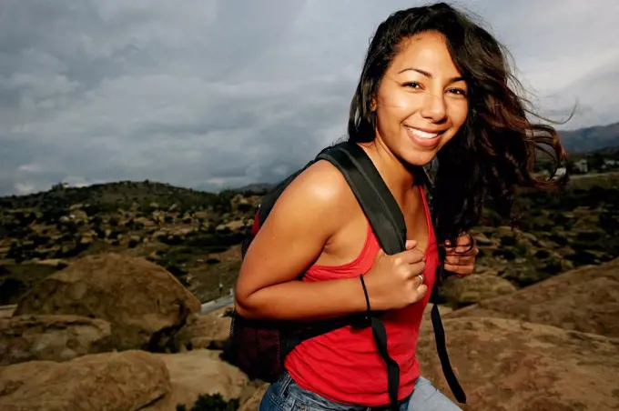 Hispanic woman smiling on rock formation