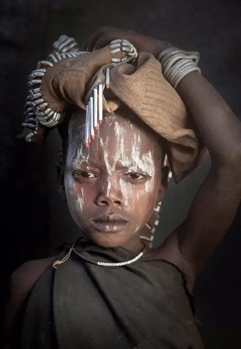 Black child wearing traditional face paint