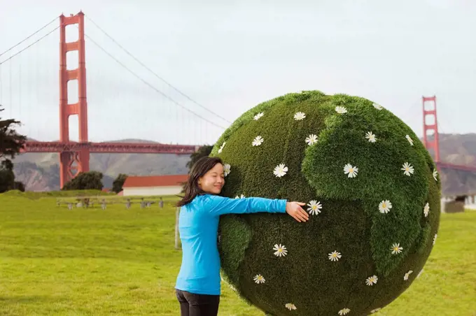 Chinese girl hugging earth topiary