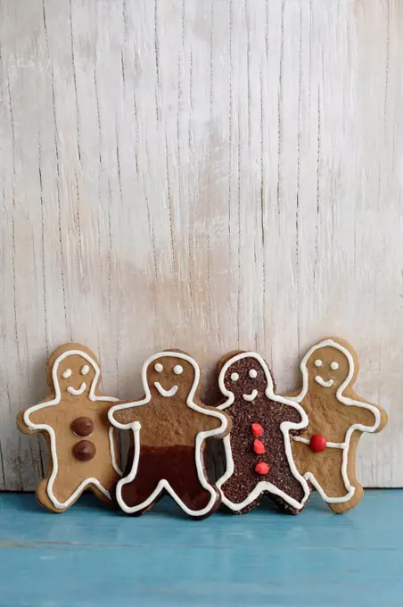 Four gingerbread man cookies in a row