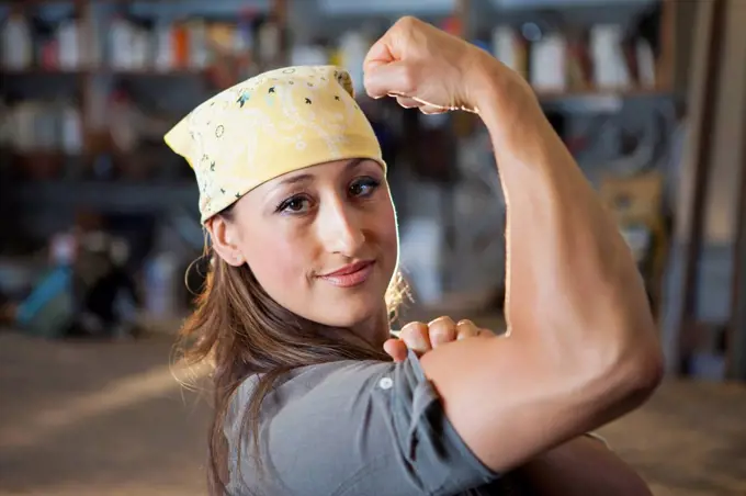 Hispanic worker flexing biceps