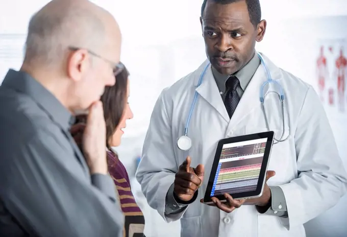 Doctor showing tablet computer to patients