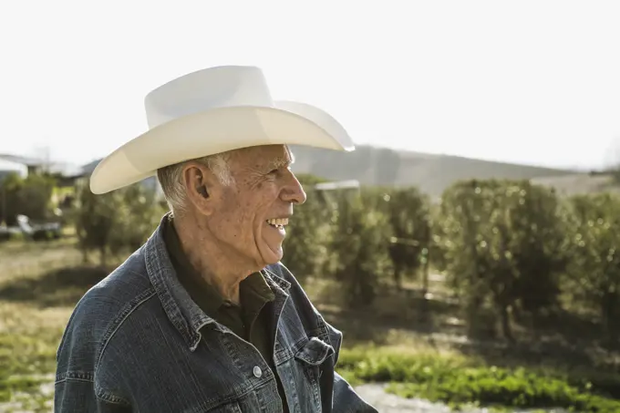 Hispanic farmer smiling in vineyard