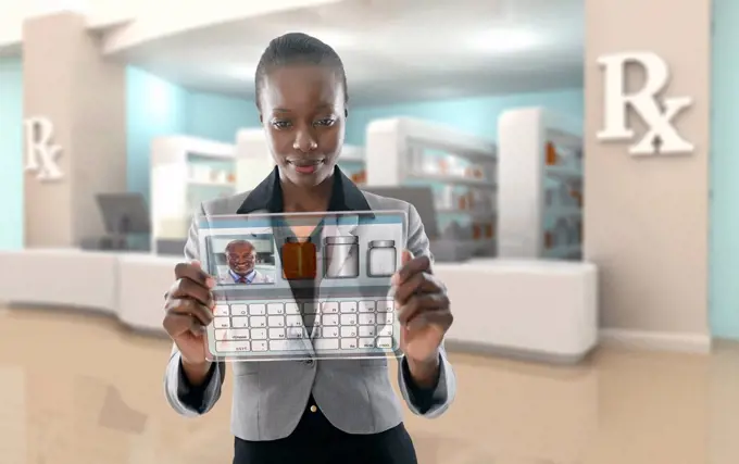 African American businesswoman using digital display in pharmacy
