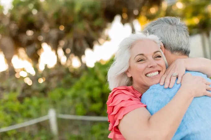 Close up of older Caucasian couple hugging