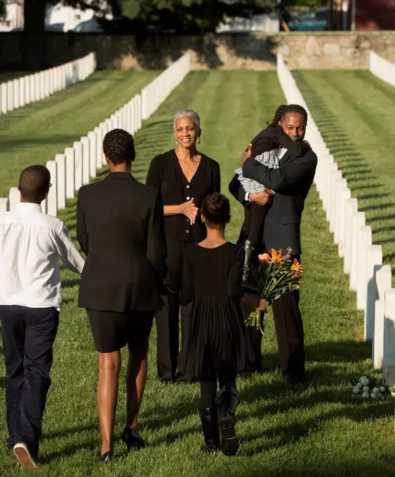 Multi-generation Black family at military cemetery