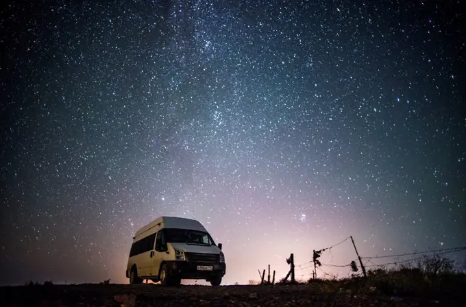 Camper van under starry sky