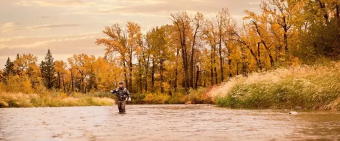 Caucasian man fishing in river