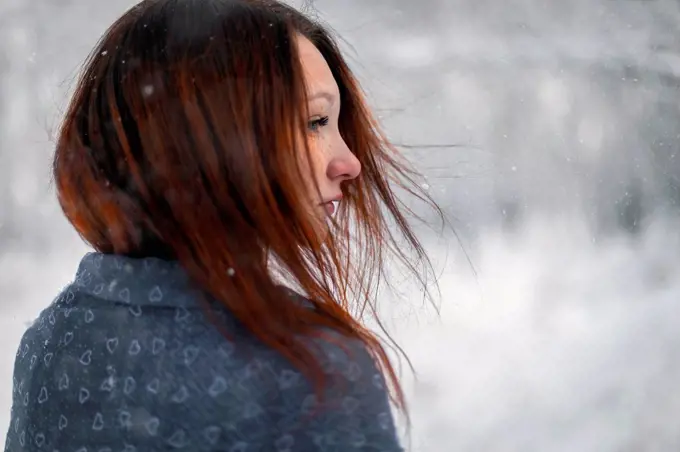 Hair of Caucasian woman blowing in wind in winter