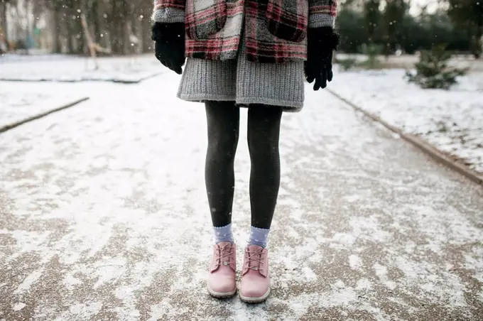 Legs of Caucasian woman standing in snow