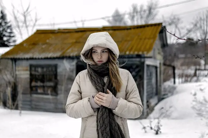 Caucasian woman wearing coat and scarf in winter