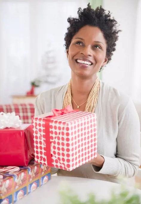 Black woman holding wrapped gift
