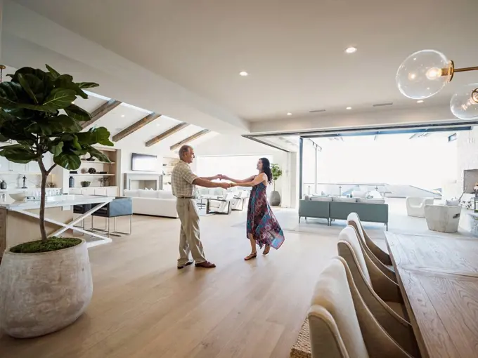 Older couple dancing in modern home