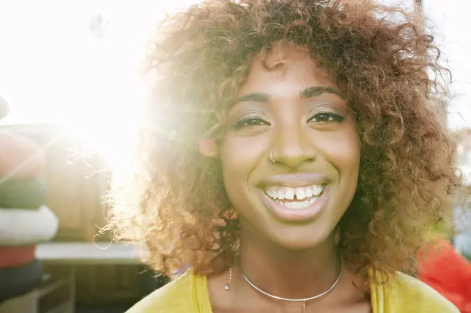 Sun beams on face of smiling black woman