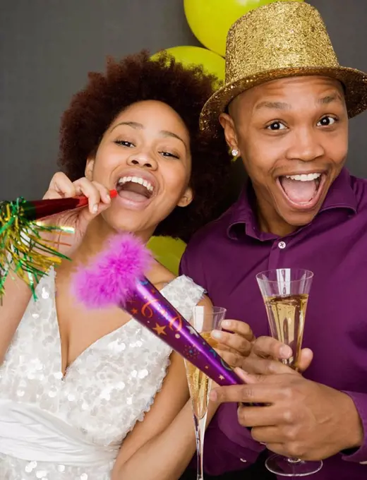 African couple in party hats on New Years Eve
