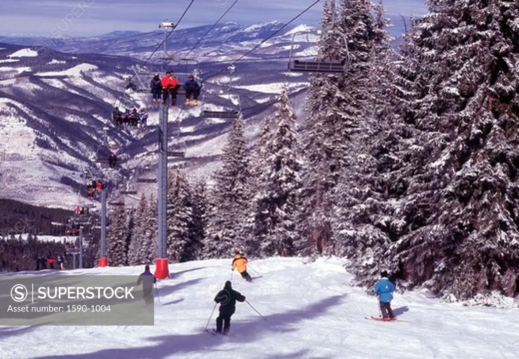 USA, Colorado, Vail, People going down ski slope