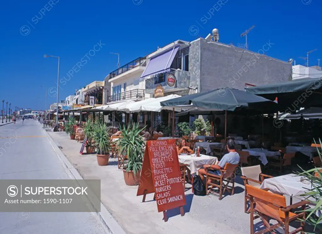 Greece, Kos Island, Kardemena, People relaxing in sidewalk cafe