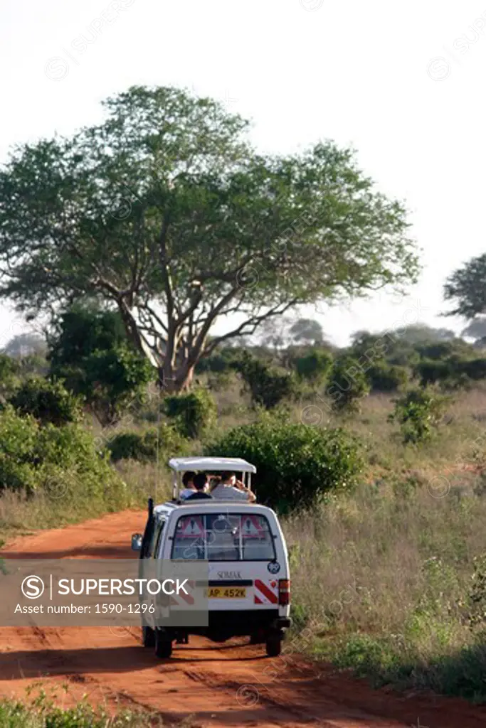 Kenya, Tsavo National Park, Safari vehicle negotiating dirt road
