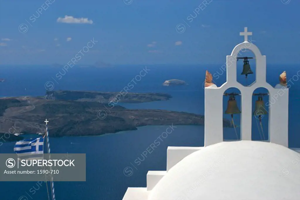 Greece, Santorini, Imerovigli, View of church bell tower with Greek flag