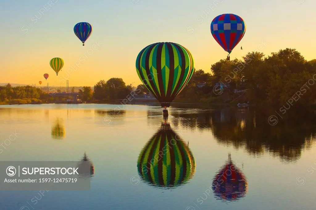 hot air balloons over lake