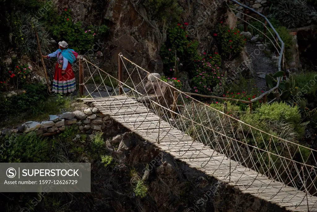 woman on swing bridge in Colca Canyon in Peru